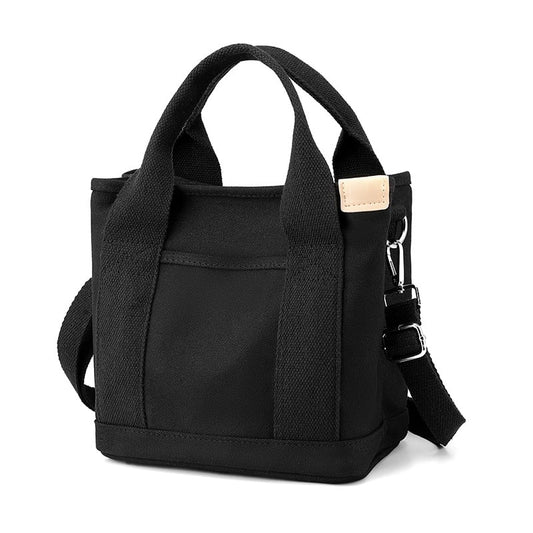 Schwarze Canvas-Tasche mit Tragegriffen und Schultergurt, modisch und praktisch für den Alltag.
