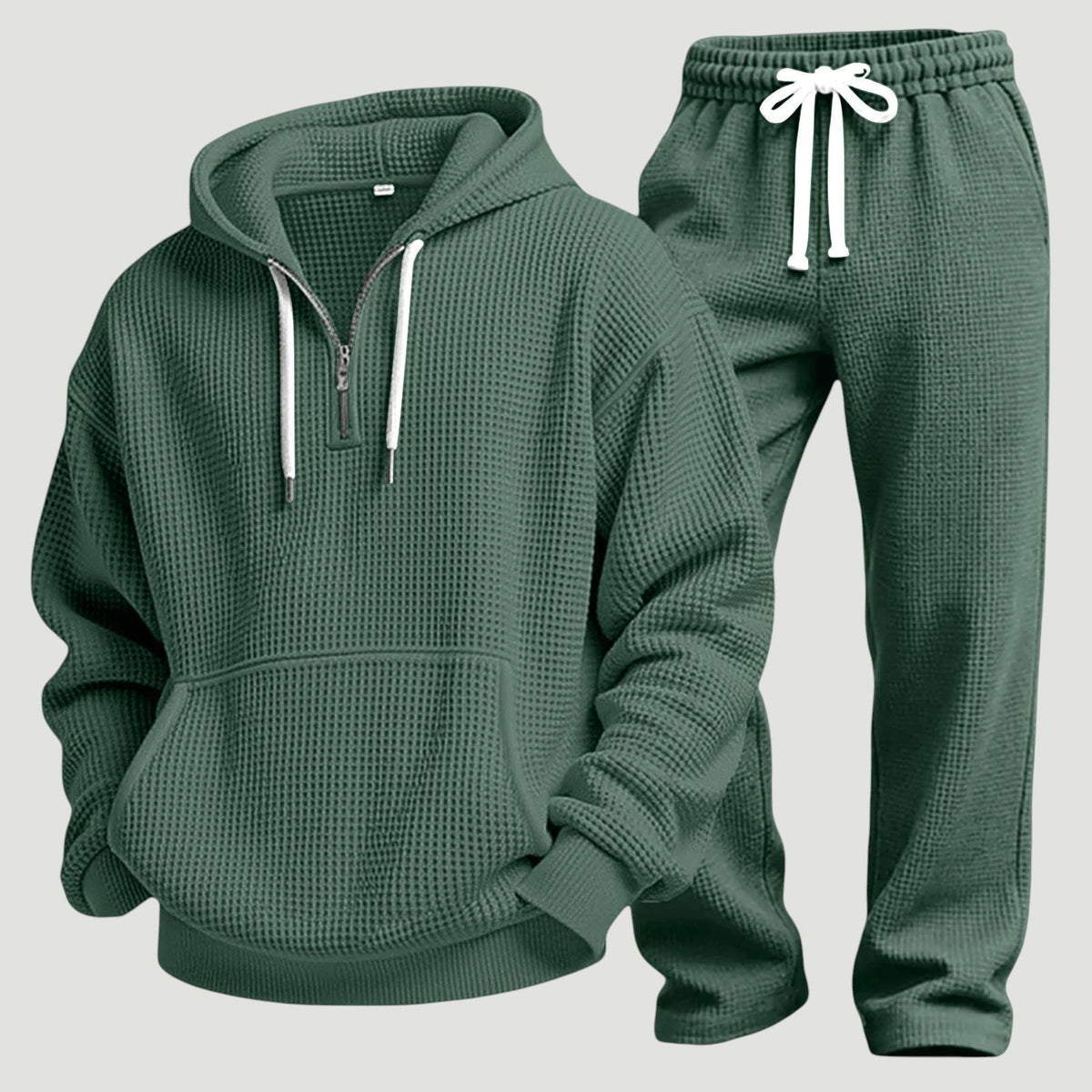 Grönt set av våffelstickad huvtröja med halv dragkedja, kängurulficka och joggingbyxor med vitt dragsnöre, fristående produktbild. 11
