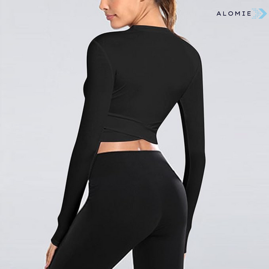 Frau in schwarzem Sport-Set, langärmeliges Oberteil und Leggings, Fitnessmode, Rückansicht.