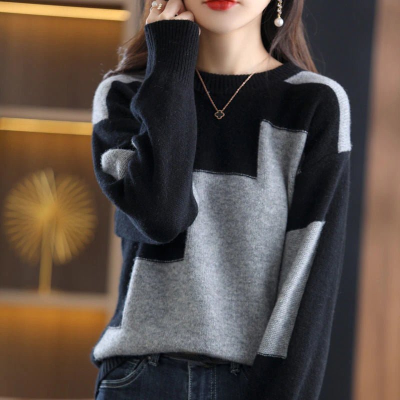 Frau trägt schwarz-grauen Pullover, geometrisches Muster, elegantes Design, Herbstmode.