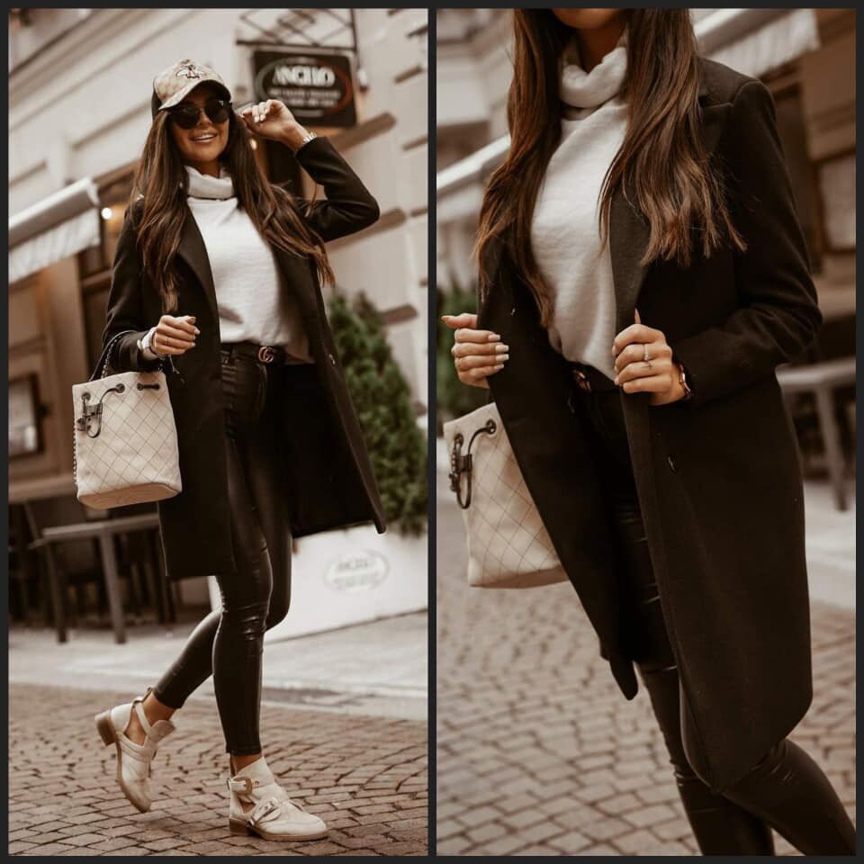 Frau in schwarzem Mantel, weißem Pullover, Lederhose, beige Tasche, modisch, urbaner Stil.