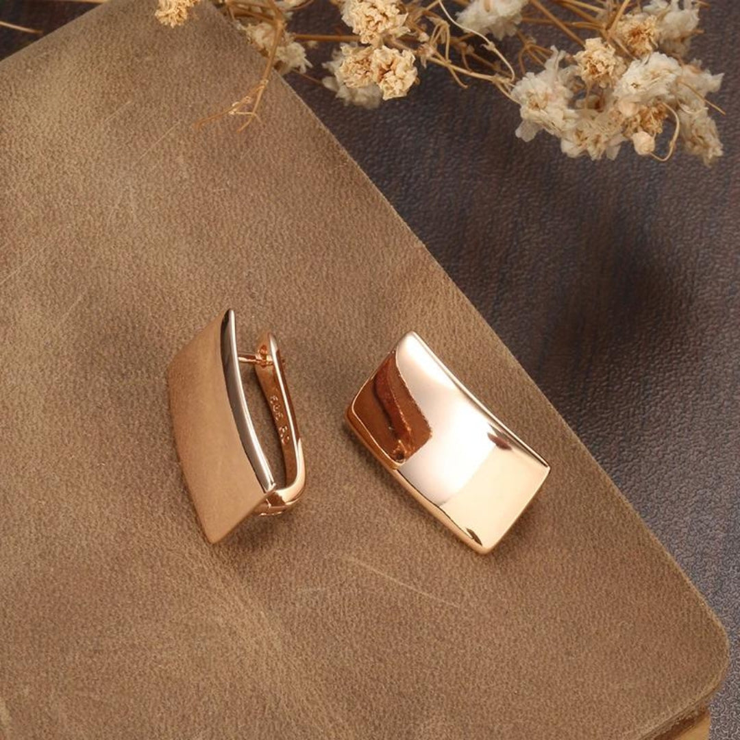 Goldene rechteckige Manschettenknöpfe auf braunem Leder, elegantes Herrenaccessoire.