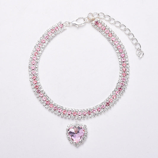 Silbernes Armband mit rosa Kristallen und herzförmigem Anhänger, eleganter Schmuck für Damen.
