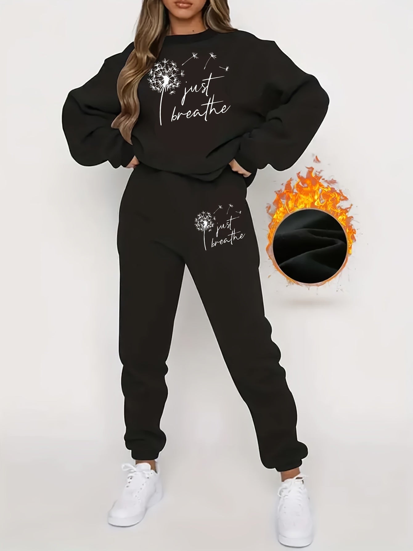 Frau in schwarzem Jogginganzug mit "Just Breathe"-Aufdruck, weiße Sneaker, gemütliche Mode.