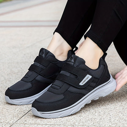 Schwarze Damen-Sneaker mit Klettverschluss, bequem, atmungsaktiv, ideal für Freizeit und Sport.