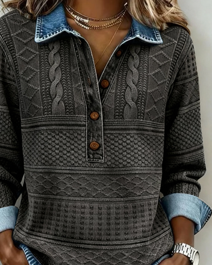 Närbild på mörkgrå tröjas denimkrage, knapplist och flätade mönsterpartier på modellen 6