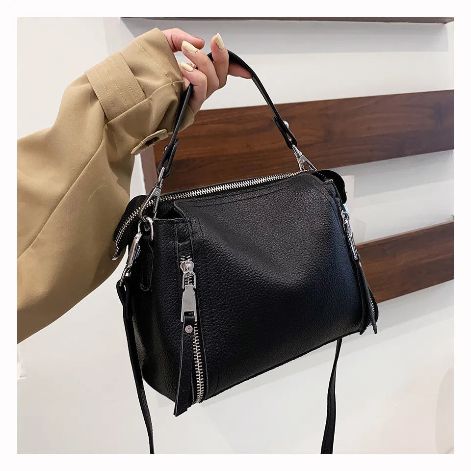Schwarze Lederhandtasche mit Reißverschlüssen, Damenmode, elegantes Accessoire.