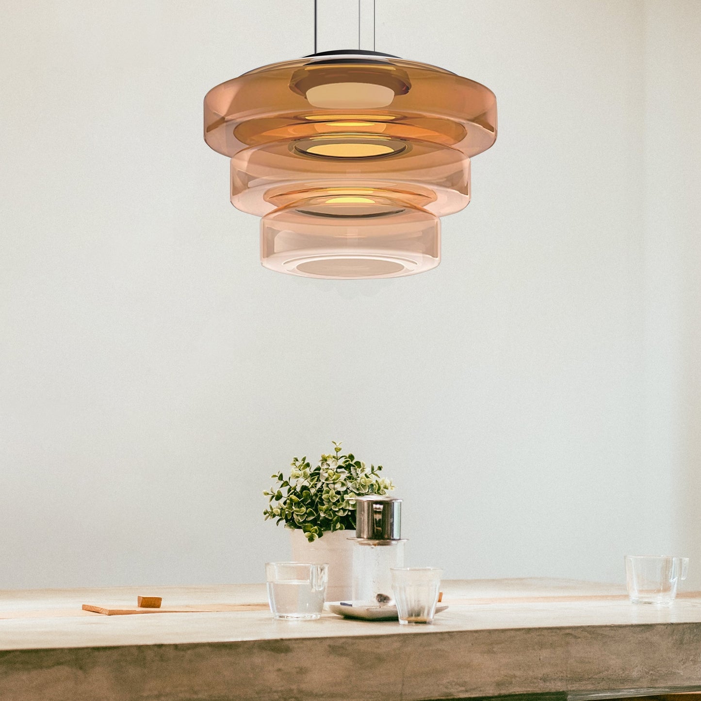 Moderne Pendelleuchte aus Glas in Braun über Esstisch, skandinavisches Design.