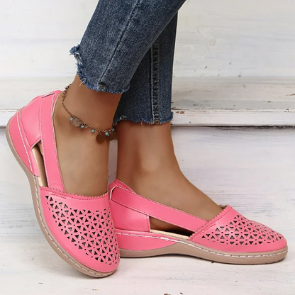Frau trägt rosa Damen-Loafer aus Leder mit Cut-Outs, kombiniert mit blauen Jeans.