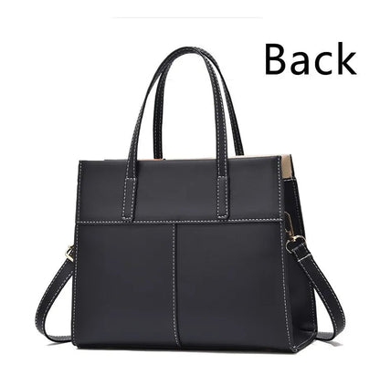 Schwarze Lederhandtasche mit Tragegriffen und Schulterriemen, elegante Damenmode.