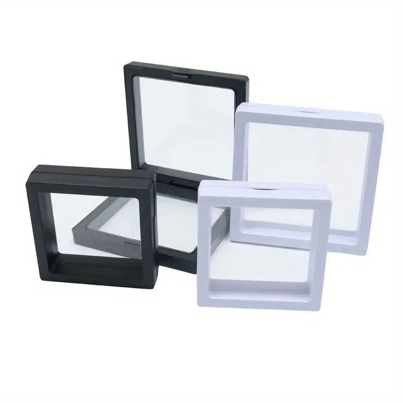 Schwarze und weiße schwebende Rahmen für Sammlerstücke, quadratisch, Kunststoff, transparent.