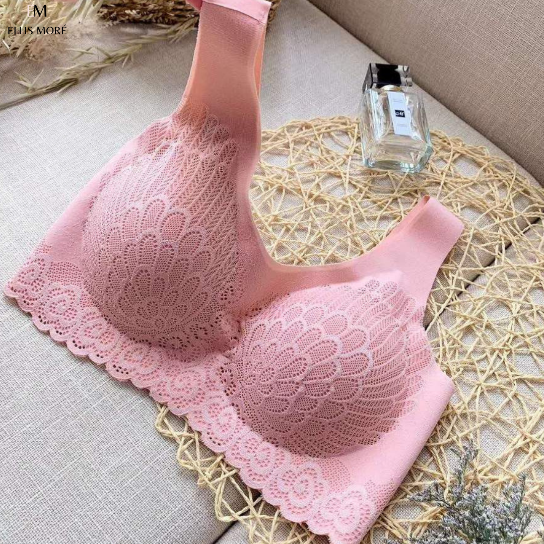 Rosa Spitzen-BH ohne Bügel, nahtlos, bequem, Damenunterwäsche, auf Sofa drapiert.