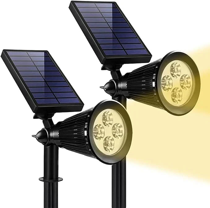 Zwei schwarze Solar-LED-Strahler mit gelbem Licht für Außenbeleuchtung.