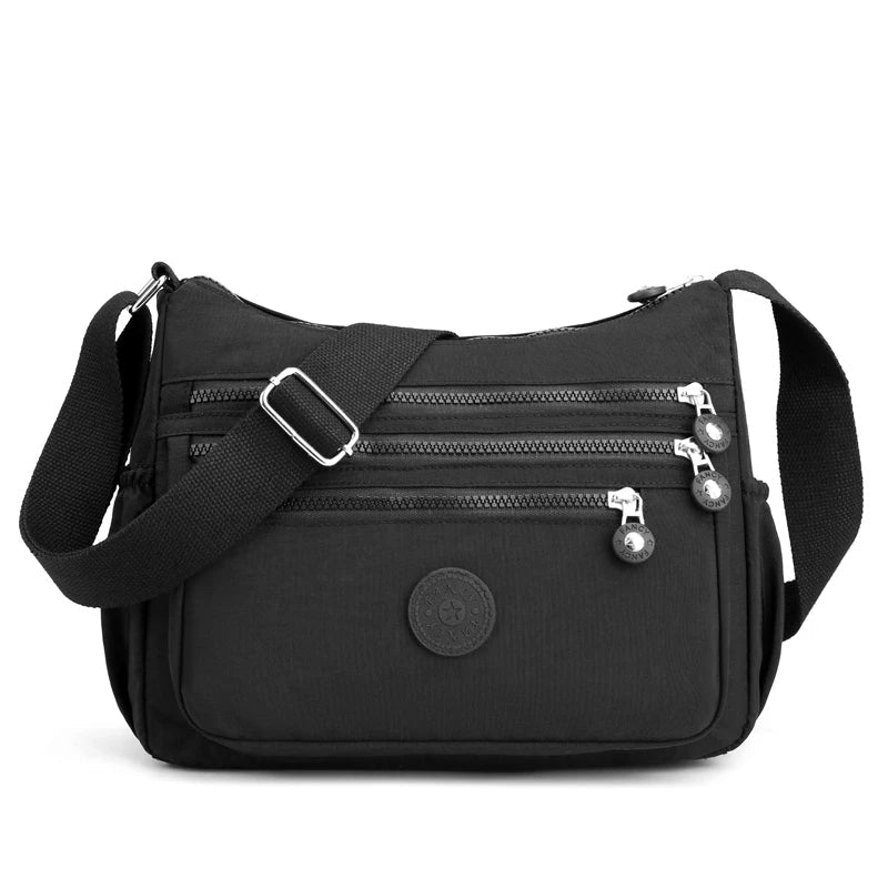 Schwarze Umhängetasche Damen, Nylon, mehrere Reißverschlüsse, verstellbarer Schultergurt.