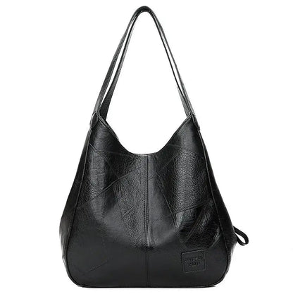 Schwarze Lederhandtasche für Damen, geräumig, modisch, mit langen Trägern, elegant.