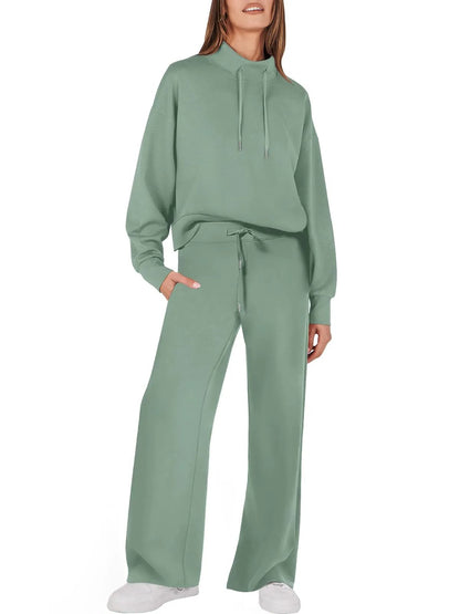 Frau in grünem Damen-Sweatshirt und Hose, Freizeitanzug, bequem, modisch, Kapuze, Taschen.