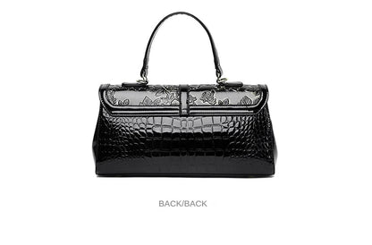 Schwarze Lederhandtasche mit Krokodilprägung, Blumenmuster, elegantes Design, Damenmode.