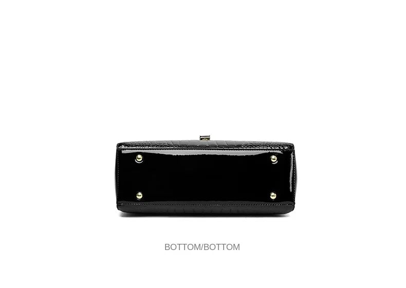 Schwarze Lederhandtasche, glänzend, rechteckig, mit goldenen Nieten, elegante Damenmode.