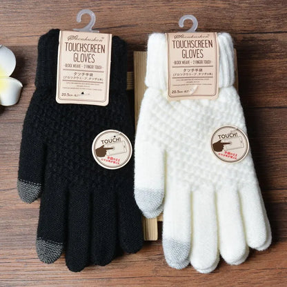 Schwarze und weiße Touchscreen-Handschuhe, gestrickt, für Smartphones geeignet.