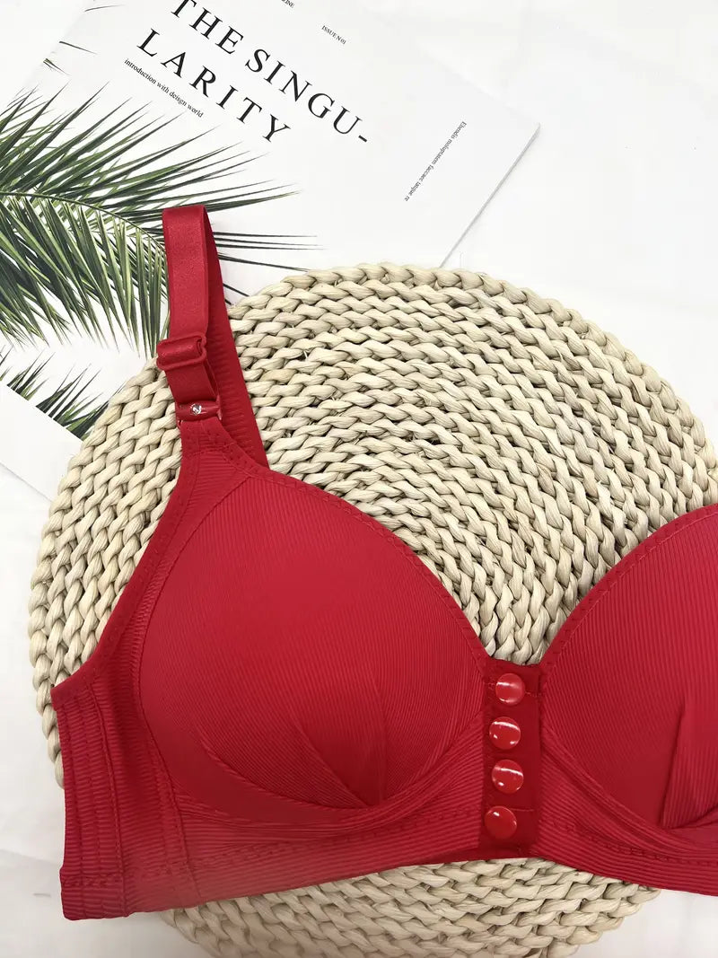 Roter BH mit Knöpfen auf geflochtener Unterlage, Damenunterwäsche, stilvoll und elegant.