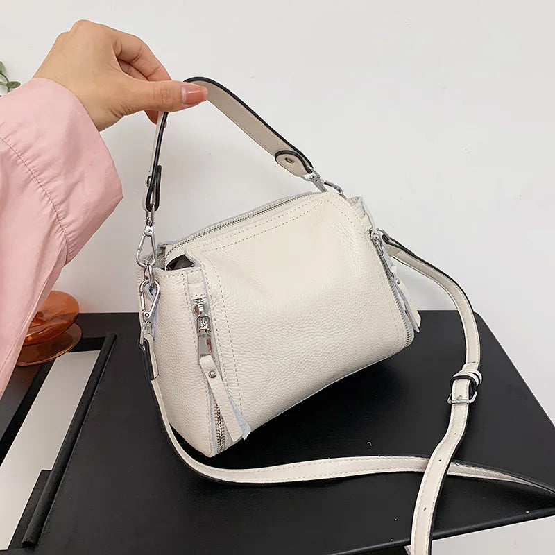 Weiße Lederhandtasche mit Reißverschluss, verstellbarem Riemen, modisch, elegant, Damenaccessoire.