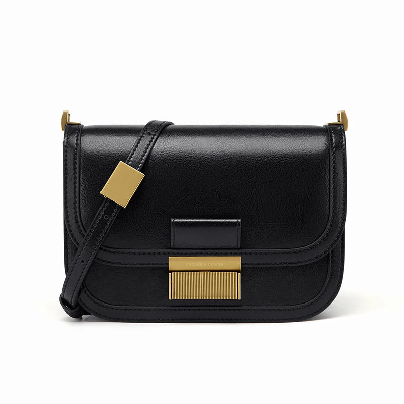 Schwarze Lederhandtasche mit goldenen Details, elegante Umhängetasche für Damen.