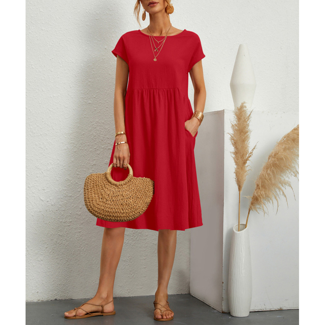 Frau in rotem Baumwollkleid, Strohtasche, Sandalen, Boho-Stil, Sommermode.