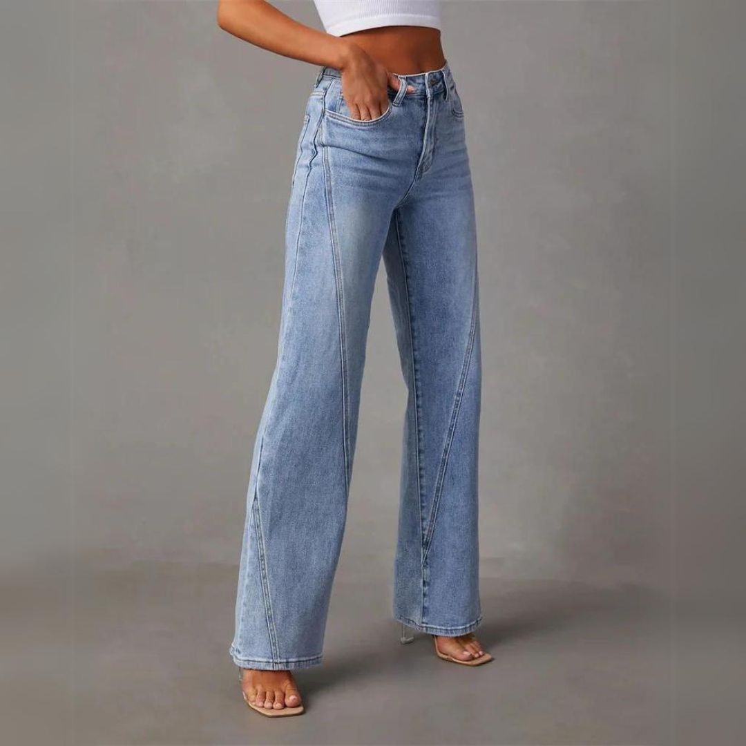 Frau in blauer, weit geschnittener Jeans und weißem Top, modisch, lässig, Streetwear.