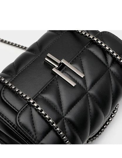 Schwarze gesteppte Ledertasche mit Kettenriemen und silbernem Verschluss.