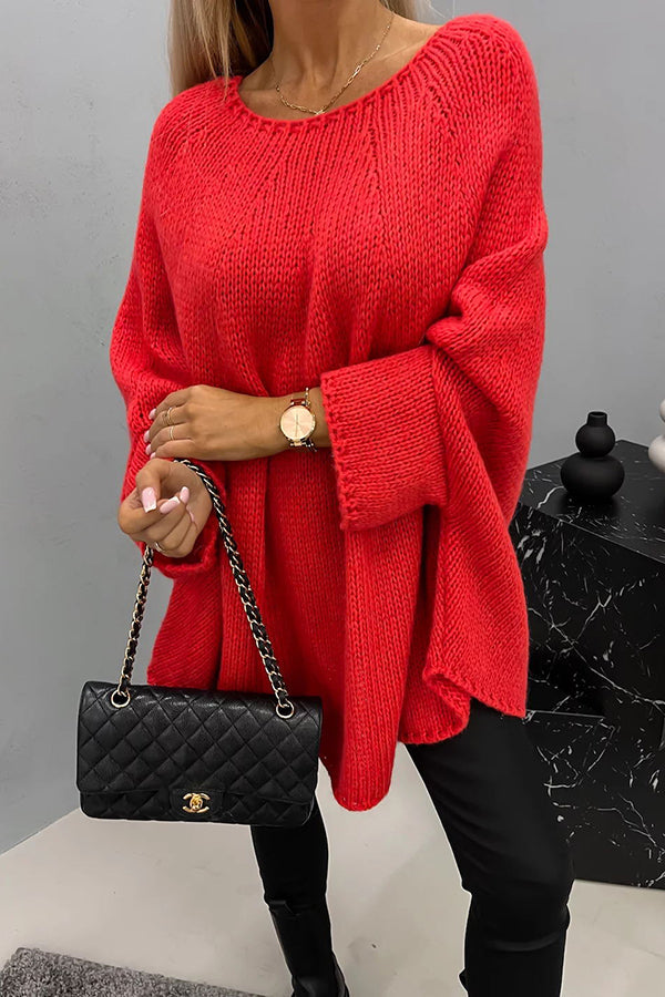 Frau in rotem Strickpullover, schwarze Lederhandtasche, goldene Uhr, modisch, elegant.