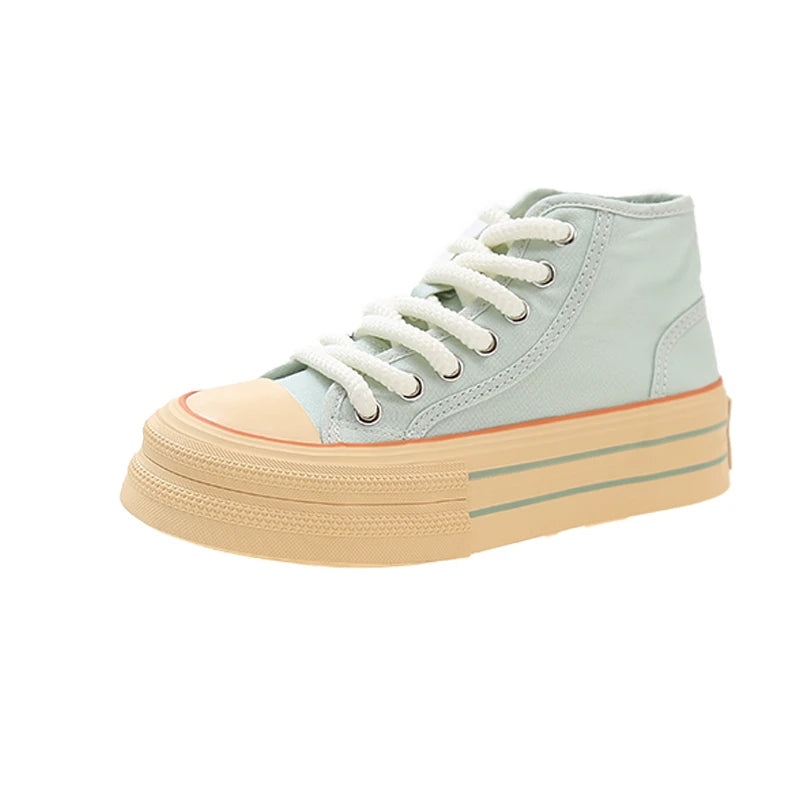 Mintgrüner High-Top-Sneaker mit dicker Sohle, beige Akzente, weiße Schnürsenkel.