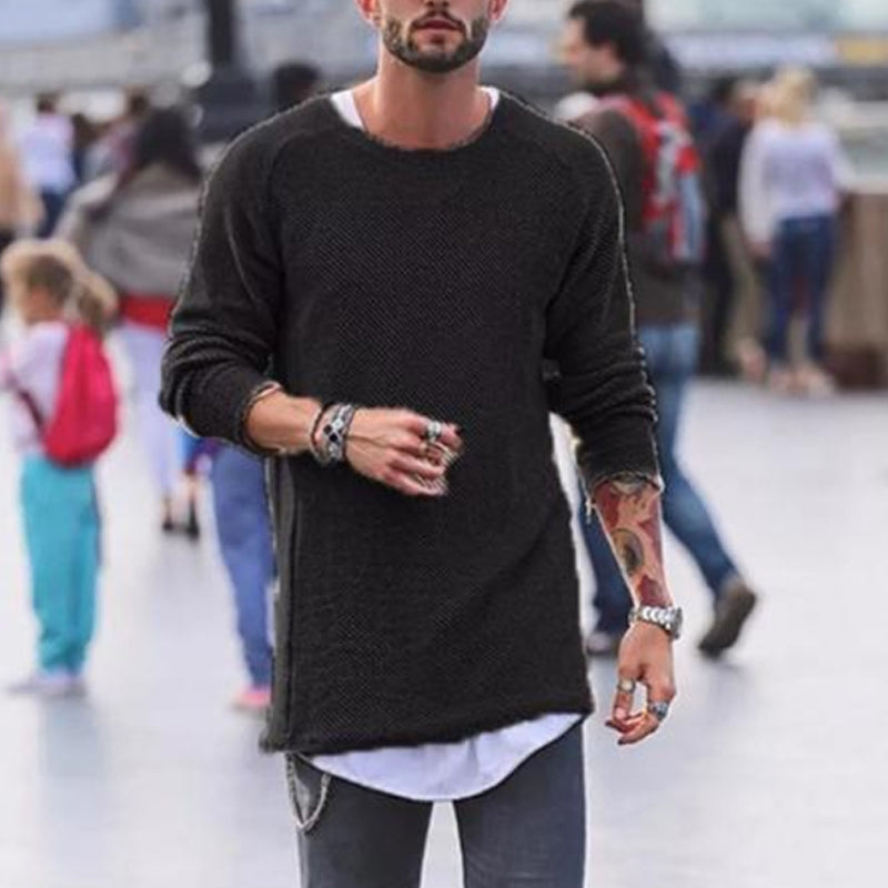 Mann in schwarzem Strickpullover, lässiger Stil, urbaner Hintergrund, modische Accessoires.