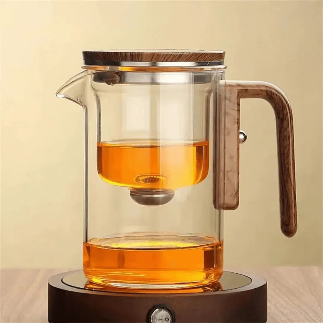 Glas-Teekanne mit Holzgriff, modern, transparent, auf runder Basis, ideal für Teezubereitung.