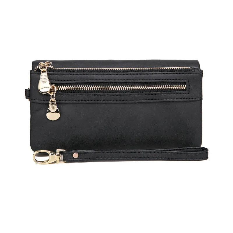 Schwarze Lederhandtasche mit Reißverschlüssen und abnehmbarem Riemen, elegant und praktisch.