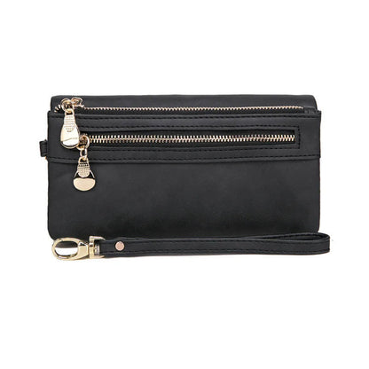 Schwarze Lederhandtasche mit Reißverschlüssen und abnehmbarem Riemen, elegant und praktisch.