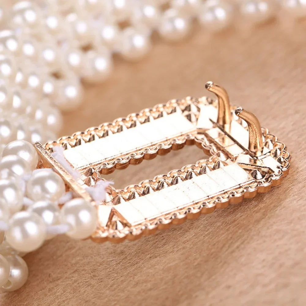 Perlengürtel mit goldener Schnalle, elegantes Design, Damenmode-Accessoire, Nahaufnahme.