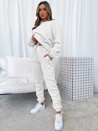 Frau in weißem Jogginganzug, lässig, modern, bequem, Wohnzimmer, Mode, Freizeitkleidung.