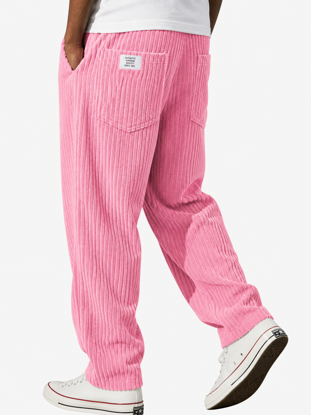 Rosa manchesterbyxa bakifrån på gående modell med vit t-shirt, bakficka, liten etikett vid midjan och vita sneakers. 11
