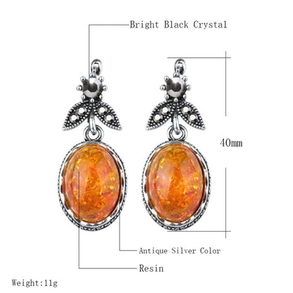 Antik-silberne Ohrringe mit orangefarbenem Harzstein, schwarzem Kristall, 40mm Länge.