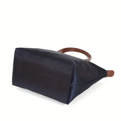 Schwarze Damenhandtasche aus Nylon mit braunen Ledergriffen, elegant und geräumig.
