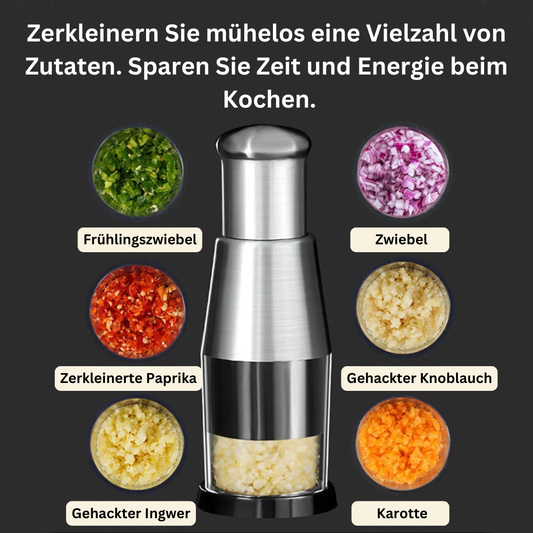 Manueller Zerkleinerer aus Edelstahl mit Zutaten: Zwiebel, Paprika, Knoblauch, Ingwer, Karotte.