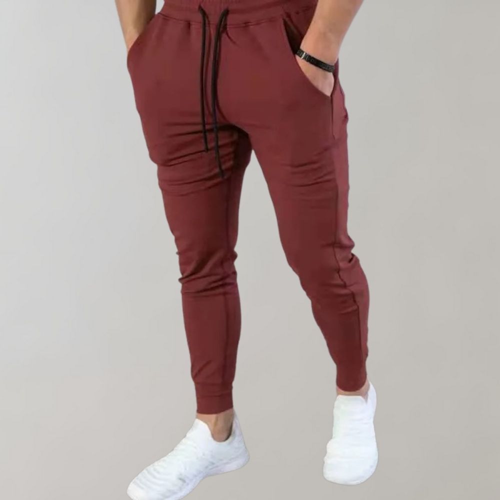 Rote Jogginghose für Herren, bequem, sportlich, mit Kordelzug, ideal für Freizeit und Fitness.