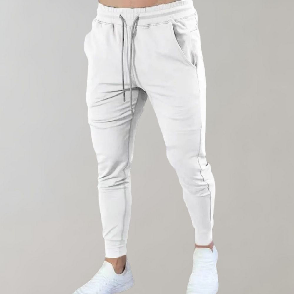 Weiße Jogginghose für Herren, bequem, elastisch, mit Kordelzug, ideal für Sport und Freizeit.