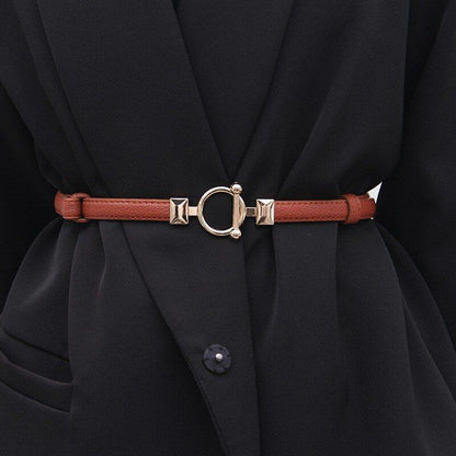 Brauner Ledergürtel mit goldener Schnalle, Damenmode, elegantes Accessoire, schwarzer Blazer.