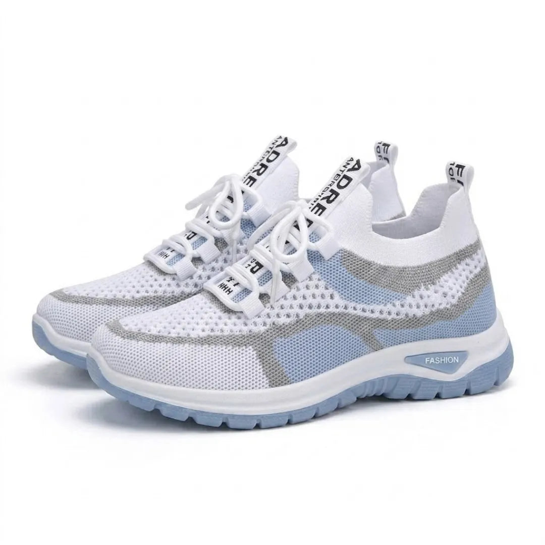 Ett par vita och ljusblå mesh-sneakers med vit snörning och blå sula, snett framifrån mot vit bakgrund. 7