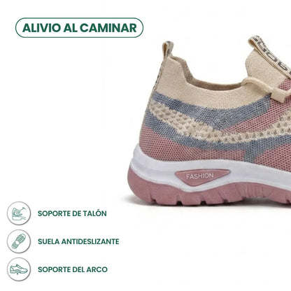 Närbild på hälpartiet av den beige sneakern med rosa och blå fält, med ikoner för häl- och hålfotsstöd. 31