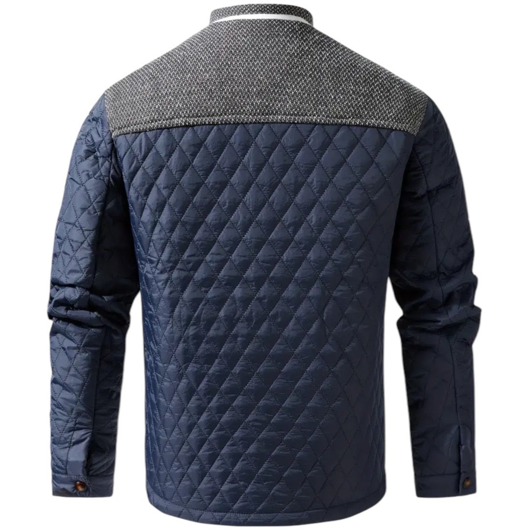Dunkelblaue gesteppte Herrenjacke mit grauem Schulterbereich, modisch und warm.