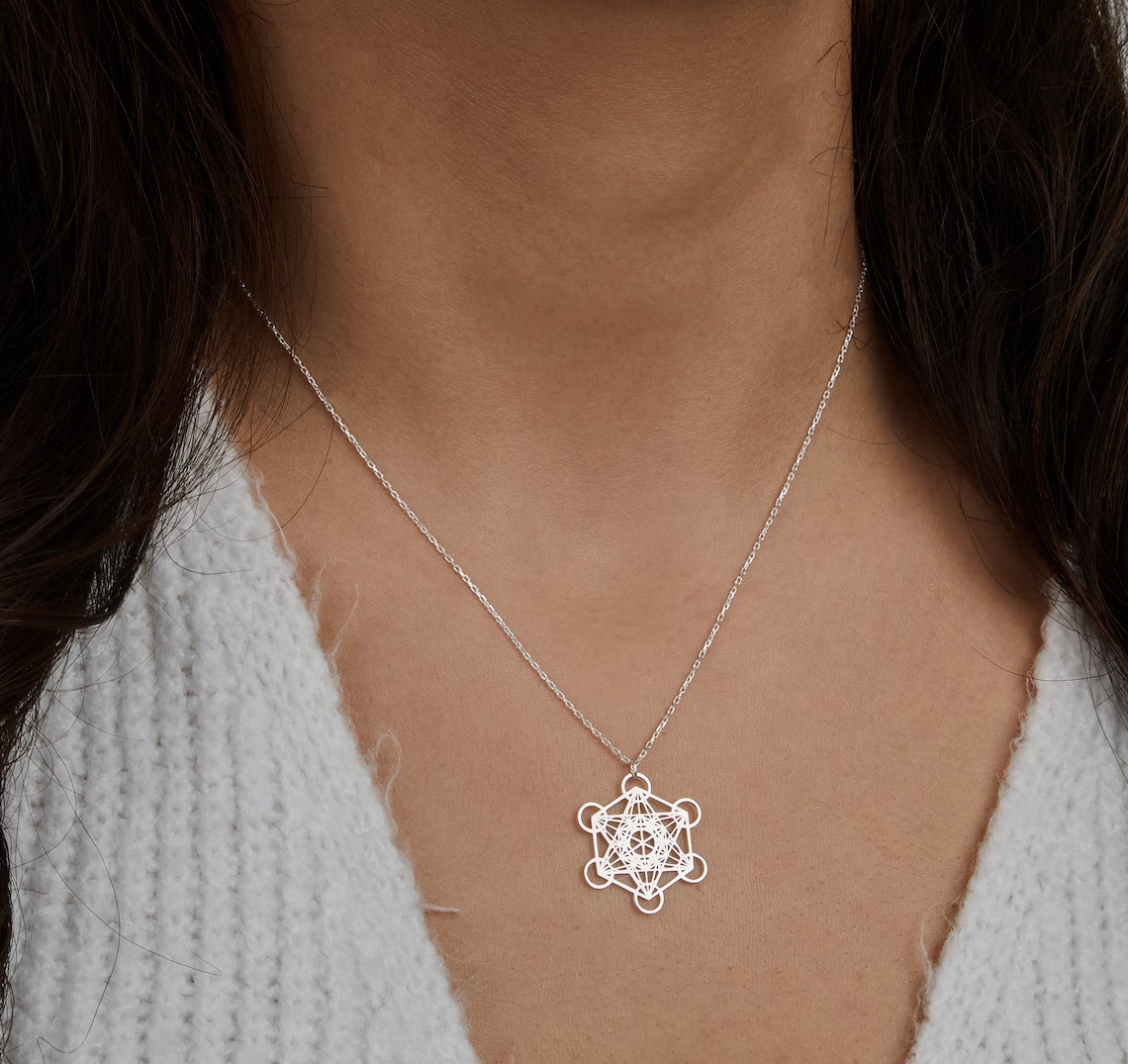 Silberne Halskette mit geometrischem Anhänger, Damenmode, eleganter Schmuck, Nahaufnahme.