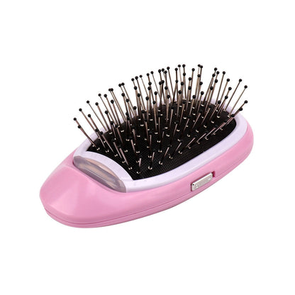 Rosa elektrische Haarbürste mit Metallborsten, ideal zum Entwirren und Stylen von Haaren.
