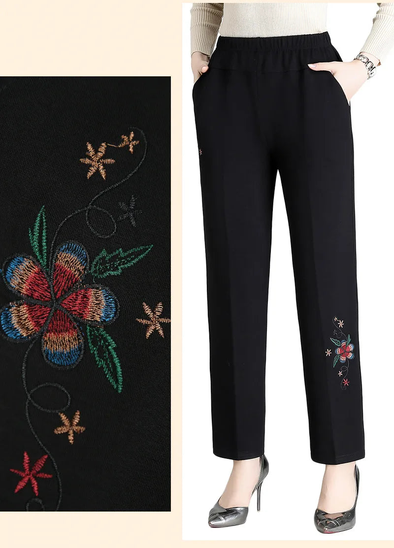 Schwarze Damenhose mit bunter Blumenstickerei, elastischer Bund, elegant, modisch.